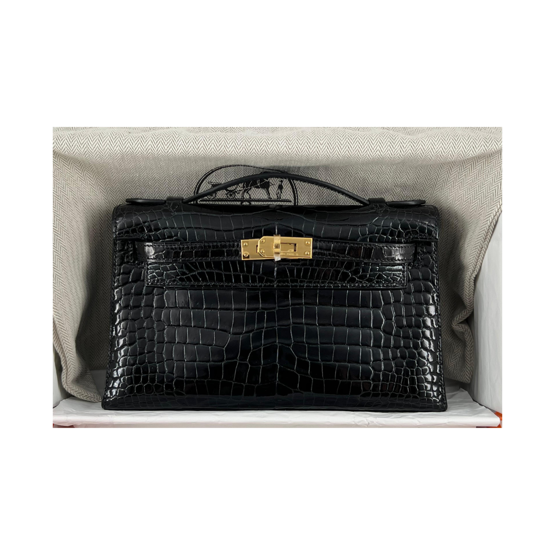 Kelly pochette black porosus lisse ghw