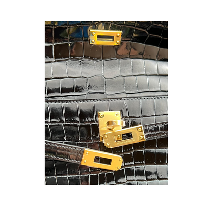 Kelly pochette black porosus lisse ghw
